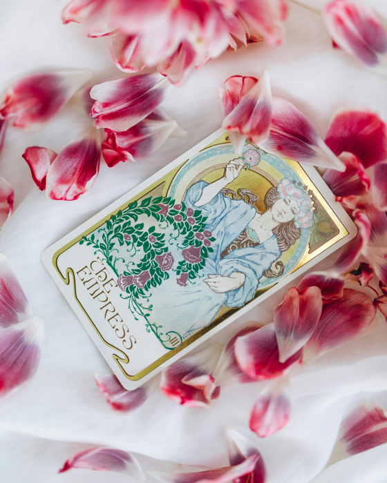 photo of the empress tarot card surrounded by pink flower petals